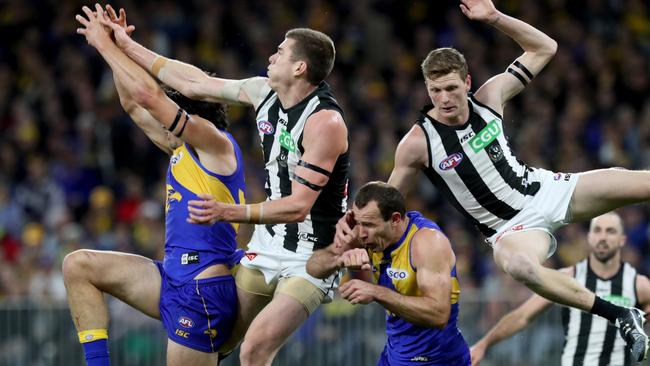 Mason Cox (second left) and Will Hoskin-Elliott fly in a marking contest against Tom Barrass and Shannon Hurn. Picture: AAP Image/Richard Wainwright.