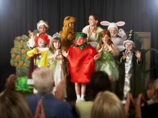 A teacher placed my girl behind a plant for her class concert