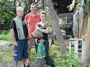 CONCERNS: Little Keen St residents, in front of the house planned for demolition, are (from left) John Trapp, Tony Gilding, Jade Bening with baby Loretta and Django Bening.