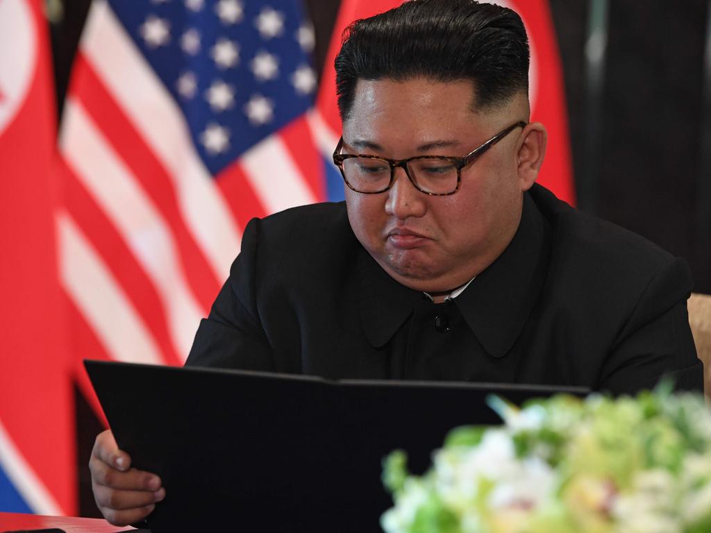 North Korea's leader Kim Jong Un looks at his document at a signing ceremony with US President Donald Trump. Picture: Saul Loeb/AFP