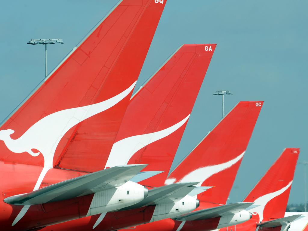 The tails of Qantas jets are seen at Sydney International Airport, Wednesday, Dec. 3, 2008. Qantas announced today, Tuesday, April 14, 2009 that more than 1500 jobs could go as it reduces capacity in the face of rapidly deteriorating trading conditions. The airline also slashed its full year pre-tax profit outlook to between $100 million and $200 million, down from its previous forecast of $500 million. (AAP Image/FILE/Dean Lewins) NO ARCHIVING