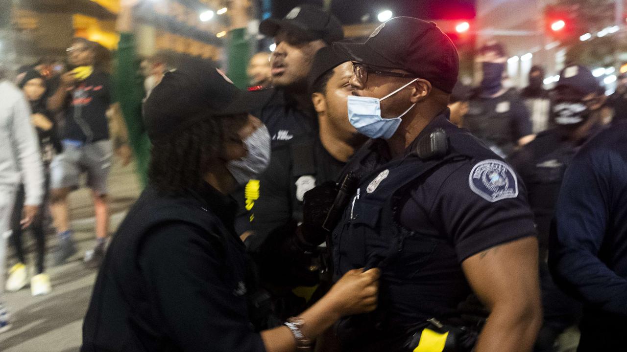 A protester grabs at the vest of a police officer in Detroit. Picture: Matthew Hatcher/Getty Images/AFP