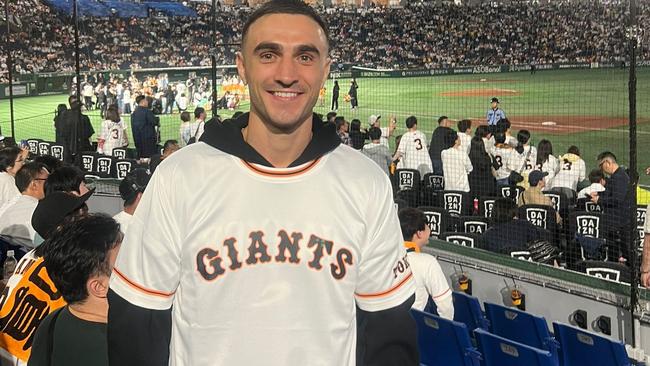 Jason Moloney attends a baseball game at Japan’s Tokyo Dome ahead of his world-title defence. Picture: Tony Tolj.