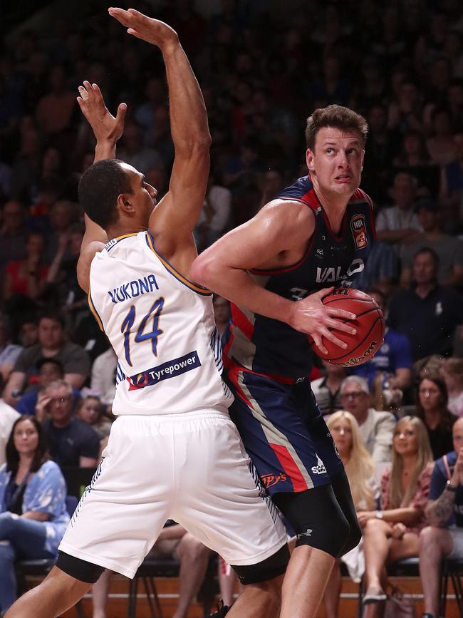 Daniel Johnson looks for the net under pressure from Mika Vukona. Picture Sarah Reed