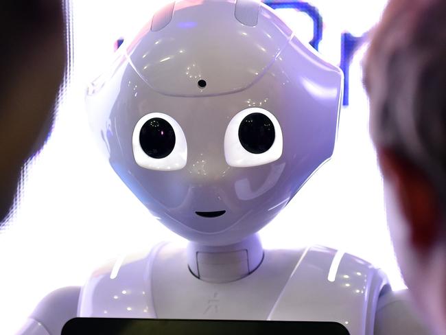 Children interact with programmable humanoid robot "Pepper", developed by French robotics company Aldebaran Robotics, is pictured during the Global Robot Expo in Madrid on January 31, 2016. The Global Robot Expo fair brings together experts who showcase their technological achievements from both the private and the public sectors. AFP PHOTO / GERARD JULIEN