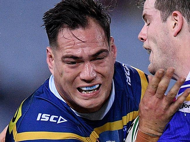 Tepai Moeroa of the Eels is tackled by Jack Cogger (left) and Lachlan Fitzgibbon of the Knights during the Round 13 NRL match between the Parramatta Eels and the Newcastle Knights at ANZ Stadium in Sydney, Saturday, June 2, 2018. (AAP Image/Dan Himbrechts) NO ARCHIVING, EDITORIAL USE ONLY