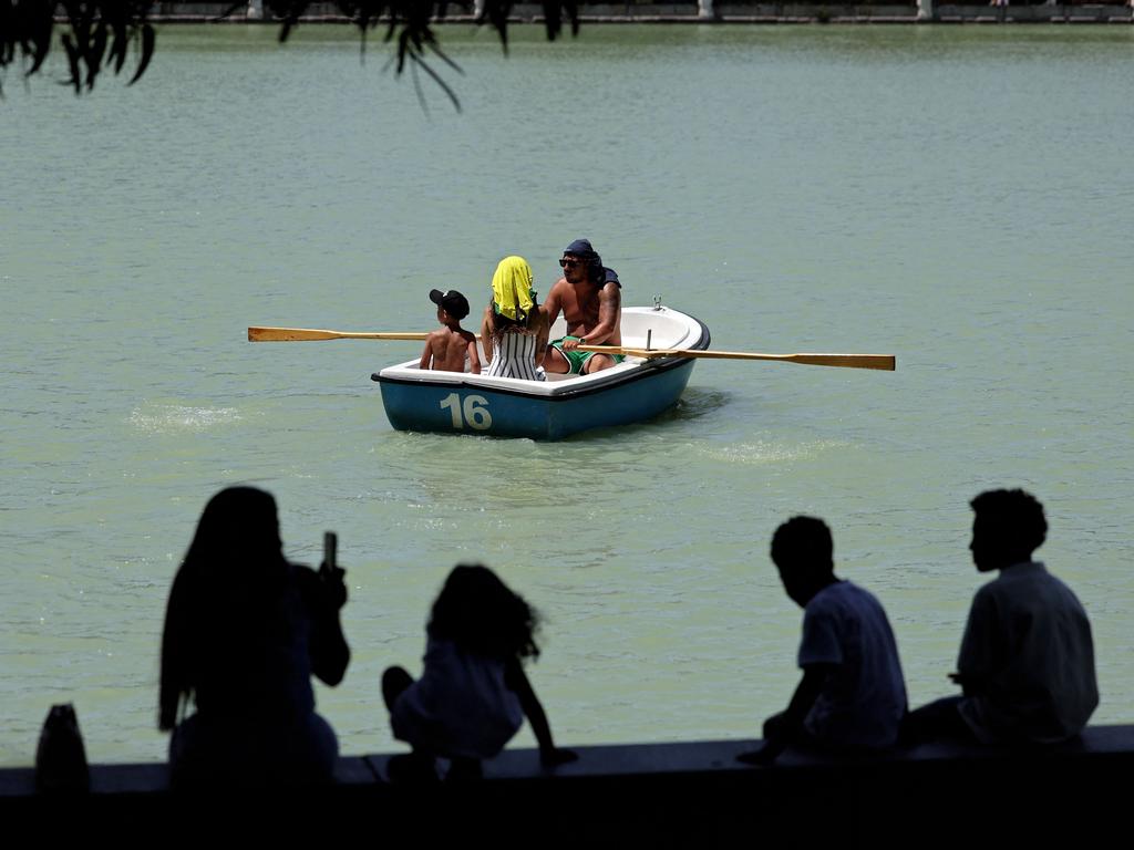 People row in a boat at the Retiro Park in Madrid during a heatwave. Picture: AFP