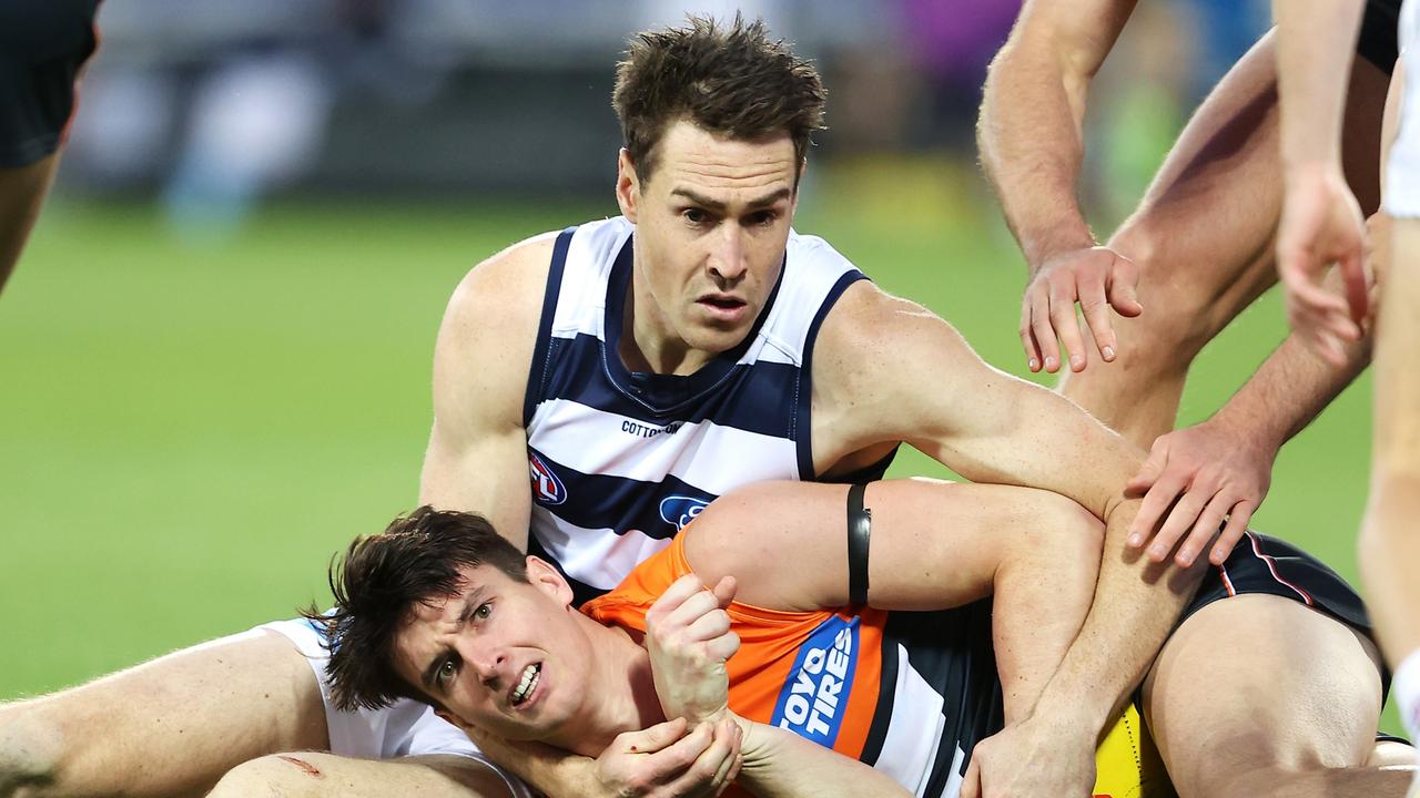 Sam Taylor of the Giants looks to the umpire after a tackle from Jeremy Cameron of the Geelong Cats. Picture: Mark Kolbe