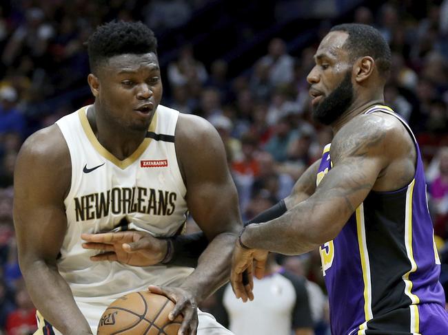 Los Angeles Lakers forward LeBron James (23) reaches for the ball as New Orleans Pelicans forward Zion Williamson (1) drives to the basket in the second half of an NBA basketball game in New Orleans, Sunday, March 1, 2020. (AP Photo/Rusty Costanza)