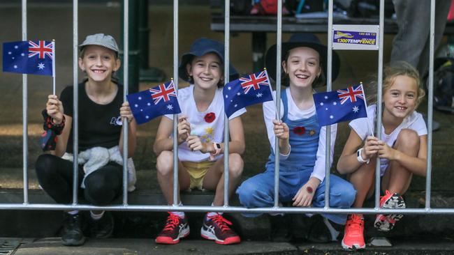 Violet Conway, 9, Olivia Morrison, 10, Claire Powell, 9, and Abby Morrison line Adelaide St in Brisbane for the 2023 ANZAC Day March. Picture: NCA NewsWire / Glenn Campbell