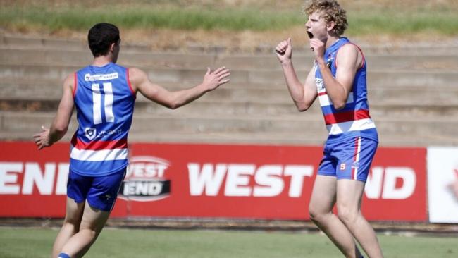 Matt LeRay (right) celebrates kicking a goal for Central District’s under-18s. Picture: Peter Argent