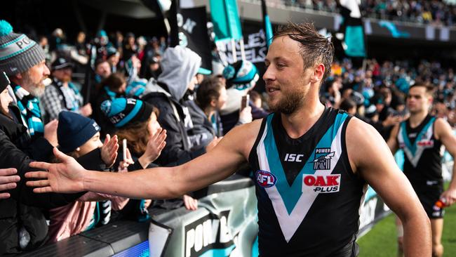 Cam Sutcliffe celebrates with Port Adelaide fans after the round 21 win against Sydney last year. Picture: Daniel Kalisz (Getty Images)