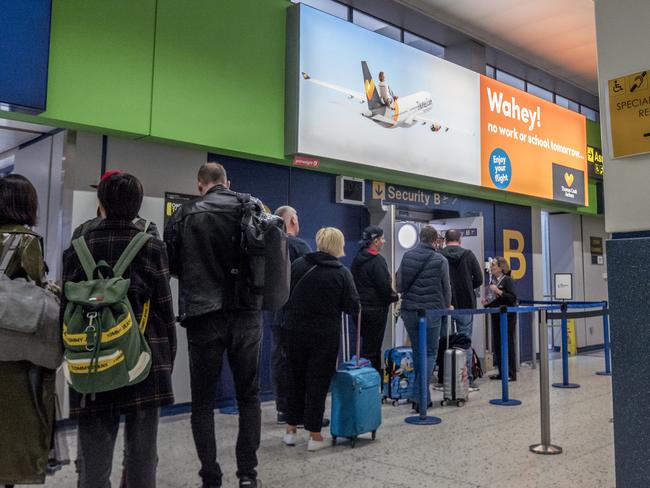 Passengers wait to go through to the Thomas Cook check-in desks at Manchester Airport on Sunday. Picture: Anthony Devlin/Getty Images
