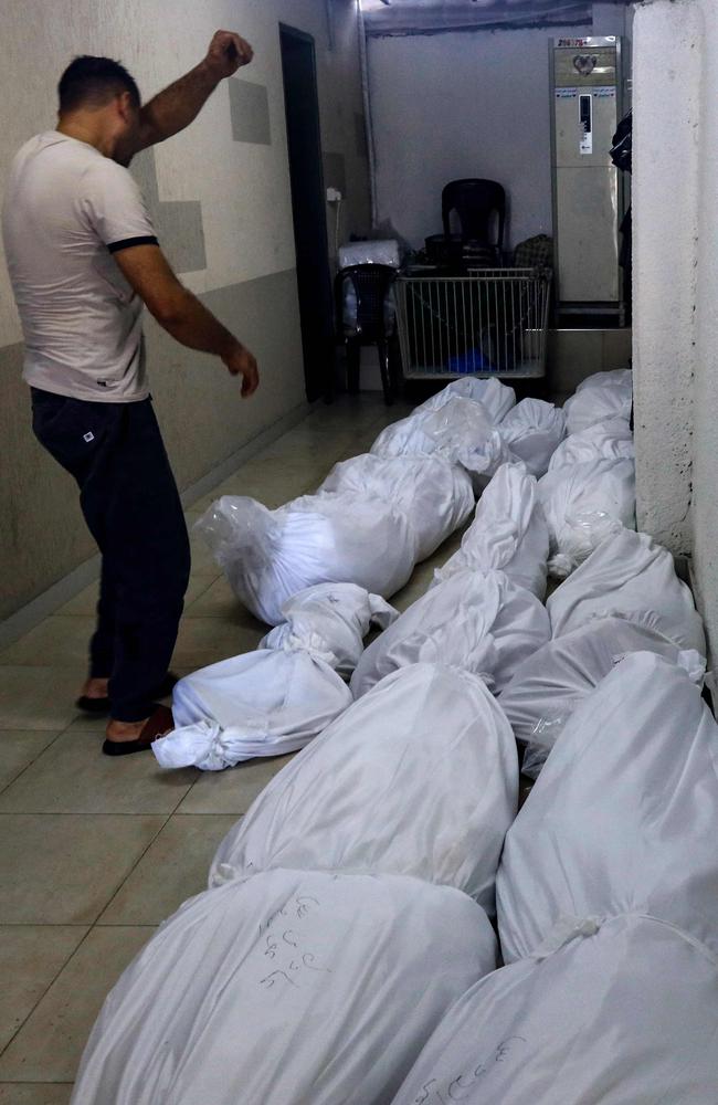 Bodies of victims killed in Israeli air strikes are piled up in a corridor in al-Shifa hospital in Gaza City. Picture: Mohammed Abed/AFP