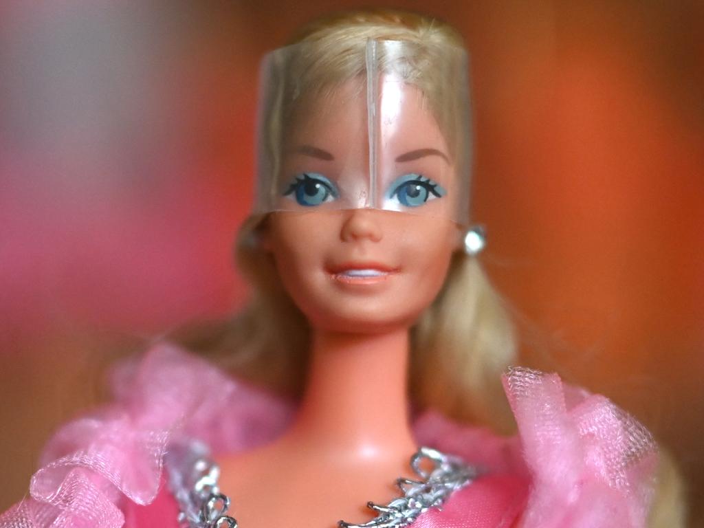 The Barbie movie has been a blockbuster around the world and stars Australia’s own Margot Robbie, but cartoonist Mark Knight suspects most Ausssie girls would rather pull on boots and kick a footy than play with their hair. Picture: supplied/Ina Fassbender/AFP