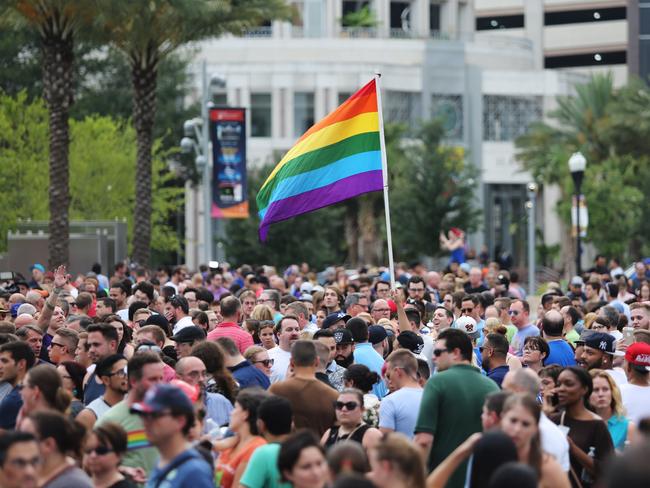 People gather at a vigil for the victims at Dr. Phillips Performing Arts Center in downtown Orlando. Picture: Ricardo Ramirez Buxeda/Orlando Sentinel via AP