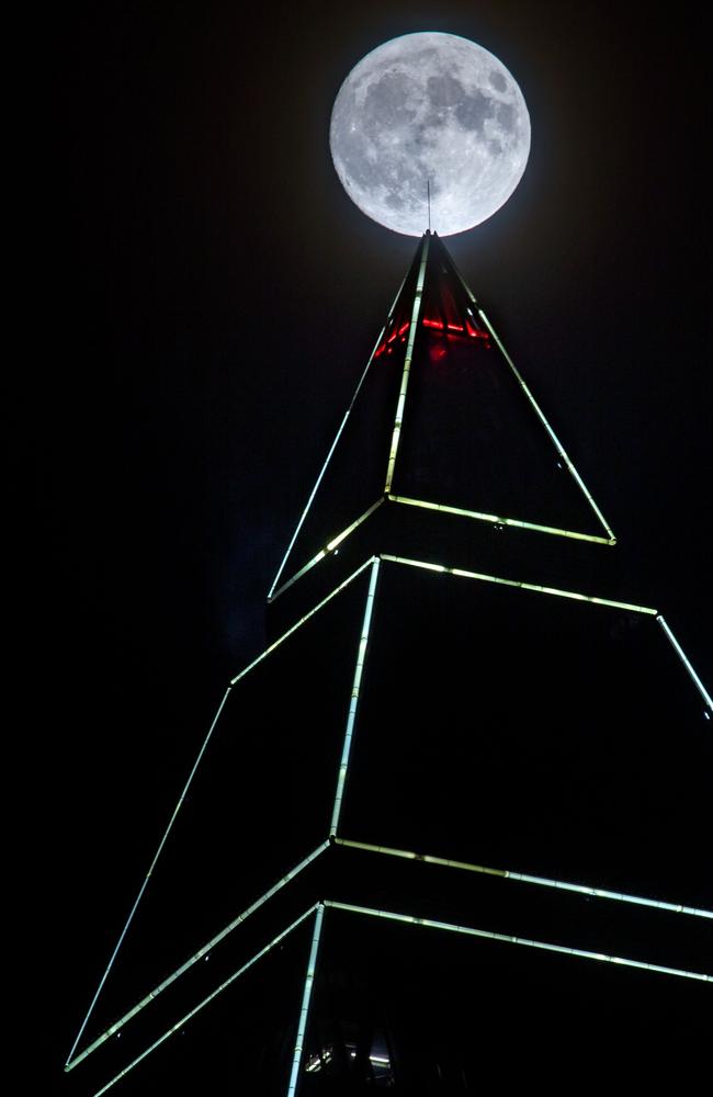 Full moon appears behind the Messeturm tower in Frankfurt am Main, western Germany, on November 13, 2016. Picture: AFP PHOTO / dpa / Frank Rumpenhorst