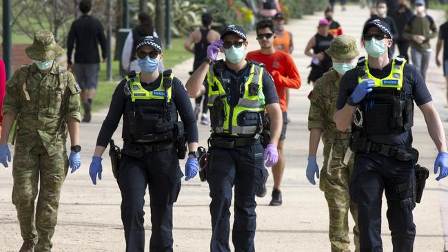 Police officers and army personnel patrol the Tan Track during stage four. Picture: David Geraghty