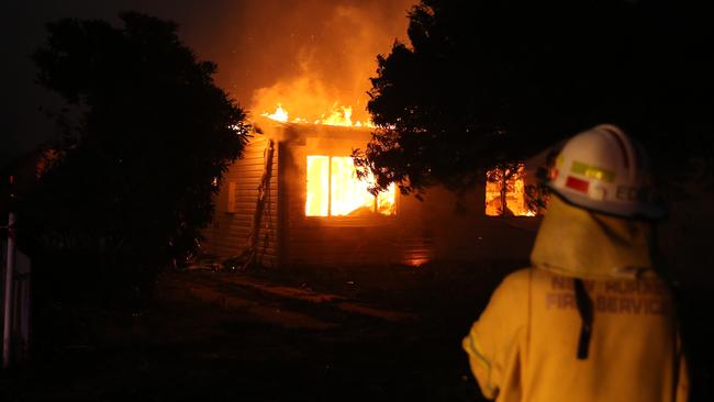 A firey looks on fire tears through a home in Batlow last night. Picture Rohan Kelly