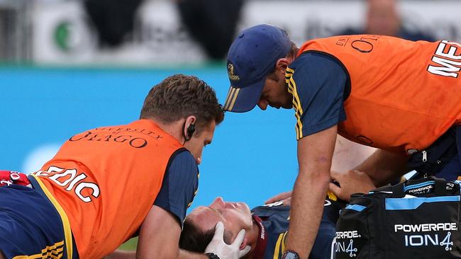 Ben Smith of the Highlanders gets medical attention after a clash for high ball with Damian McKenzie.