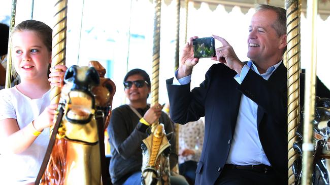 Bill Shorten on the carousel with his daughter Clementine at Luna Park in Melbourne. Picture Kym Smith.