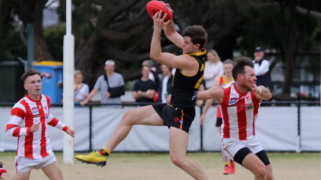 Austin Johnson marks for the Rosellas last Saturday. Pic: Andrew Keech, Cheltenham FNC