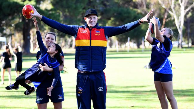 Crows AFLW player Ebony Marinoff and ruckman Sam Jacobs lead a coaching session in the north parklands earlier this year. Picture Mark Brake