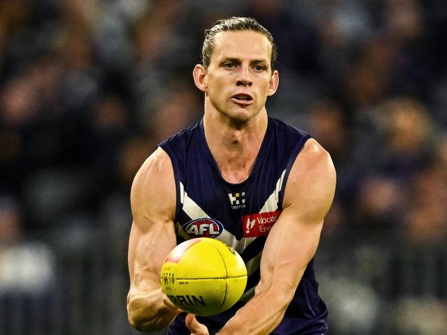 PERTH, AUSTRALIA - JULY 27: Nat Fyfe of the Dockers handpasses the ball during the 2024 AFL Round 20 match between the Fremantle Dockers and the West Coast Eagles at Optus Stadium on July 27, 2024 in Perth, Australia. (Photo by Daniel Carson/AFL Photos via Getty Images)