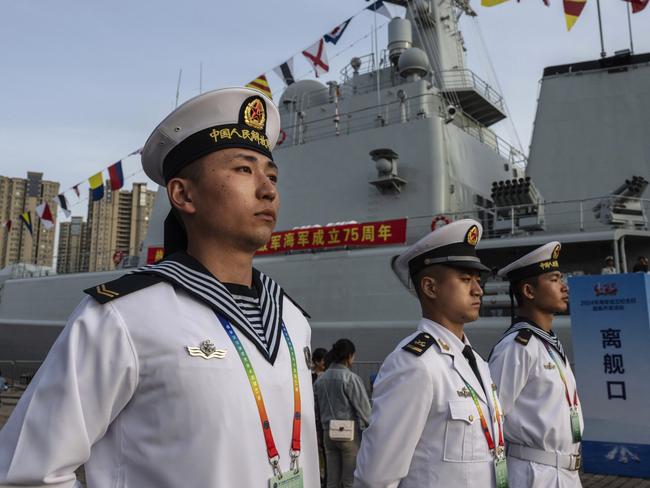 QINGDAO, CHINA - APRIL 20: Chinese sailors stand at attention next to the destroyer Shijiazhuang during an open house for the public as part of the 19th biennial meeting of the Western Pacific Naval Symposium on April 20, 2024 in Qingdao, China. China is marking the 75th anniversary of the founding of the country's navy. (Photo by Kevin Frayer/Getty Images)