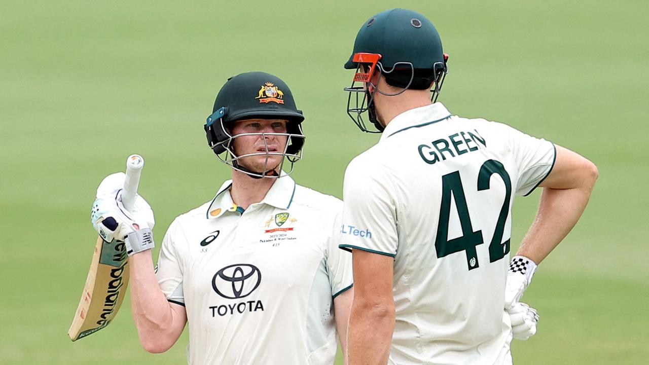 Australians Steve Smith and Cameron Green have been criticised for the amount of time spent changing gloves and having drinks between overs at the Gabba. Picture: Pat Hoelscher / AFP.-