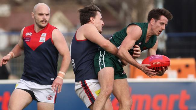 Jesse McVeigh of Airport West tackled by Kirk Lang of Tullamarine.Photo: Hamish Blair