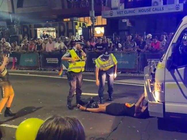 Lidia Thorpe laying down in front of the Australian Federal Police float during the Sydney Mardi Gras.