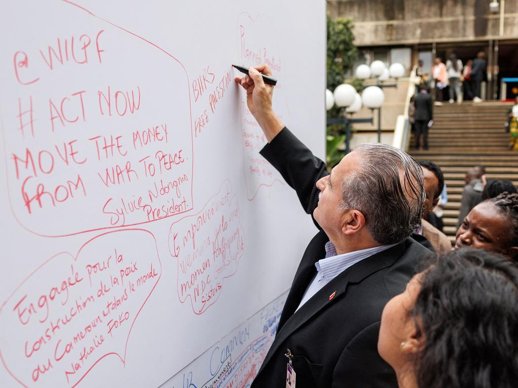 Pro-Palestinian messages are scribbled on a sign board mounted outside the plenary hall by delegates attending the 2024 United Nations Civil Society Conference. Picture: AFP