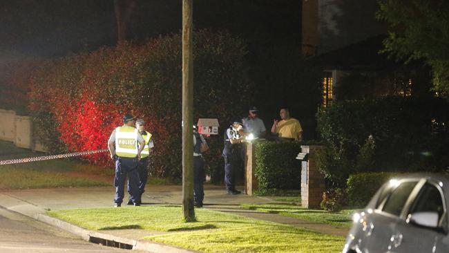 Officers speak to locals at the scene. Steve Tyson