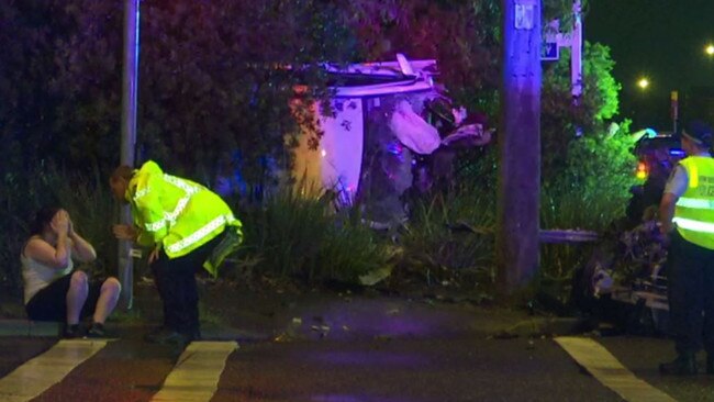 A distressed woman is comforted at the scene of the horrifying crash. Picture: TNV