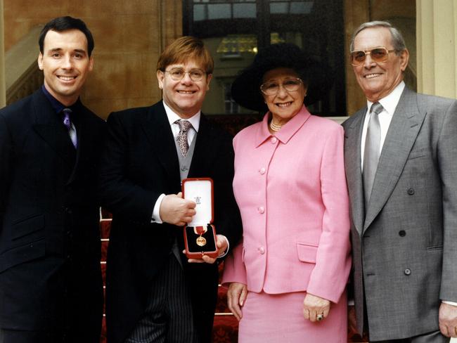 Elton John, with husband David Furnish, mum Sheila Farebrother, and stepdad Fred Farebrother, after the singer was knighted in 1998. Picture: Supplied