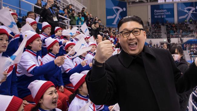 The Kim Jong-un impersonator with North Korean cheerleaders at the Korea-Japan women’s ice hockey game.