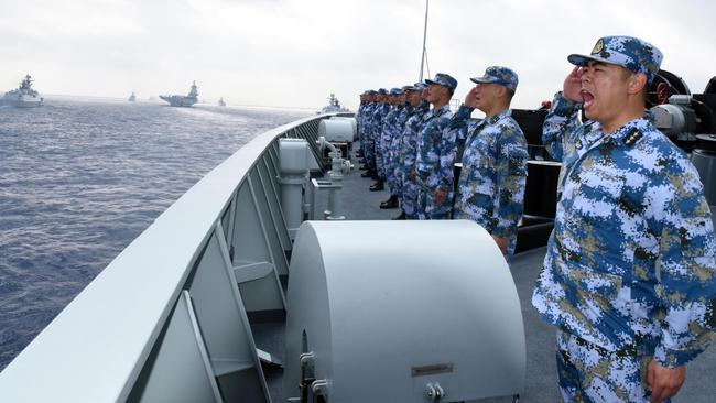 A Chinese navy fleet including the aircraft carrier Liaoning, submarines, vessels and fighter jets take part in a review in the South China Sea on April 12.