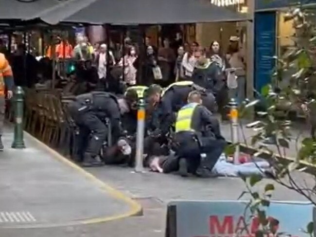 Police detain several men in Degraves St. Picture: Supplied