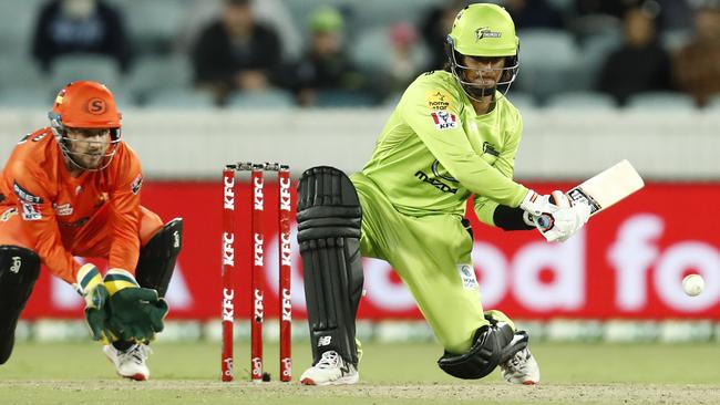 Oliver Davies hits a reverse-sweep for four during his debut innings for Sydney Thunder Picture: Getty Images