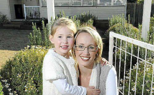 Emily Barnes cuddles up with daughter Olivia at their new family home quickly snapped up before the State Government cuts its stamp duty concession on Monday. Picture: Nev Madsen