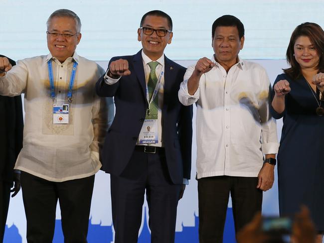 Philippine President Rodrigo Duterte, second from right, poses with a fist bump with business leaders following his address to ASEAN Business and Investment Summit. Picture: AP