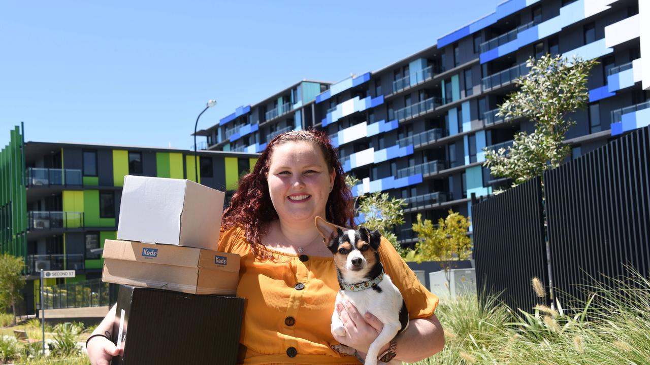 Nurse Georgia Johnson and her dog Duke are one of the first to move into the Smith Collective, the former Comm Games Village. (Photo/Steve Holland)