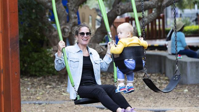 Luisa Izzolino and Michael Vecchio enjoy swinging at New Farm Park Playground. (News Corp/Attila Csaszar)