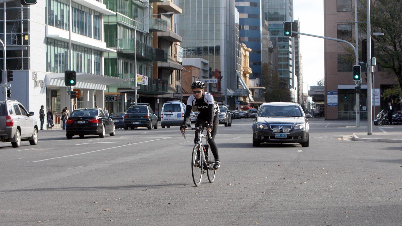 A cyclist riding on Pirie St.