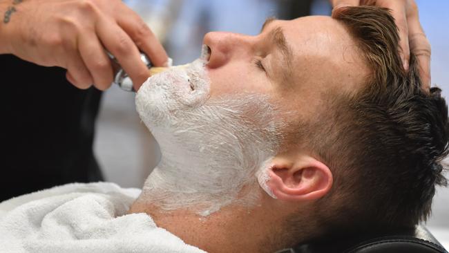 Robbie Gray has his facial hair shaved to promote Men's Health Week. Picture: Sam Wundke (AAP)