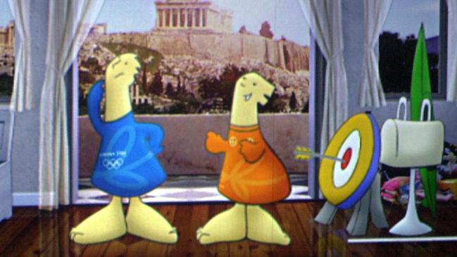 Athena, right, and Phevos, left, the mascots for the Athens 2004 Olympics are projected on a video wall with the ancient Parthenon behind them. Picture: AP