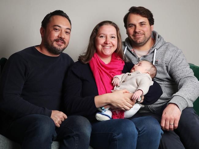 Daniel Gray-Barnett, Mollie D’Arcy, Daniel Barnett and baby Till Barnett. D'Arcy carried Till as a surrogate for the couple. Picture: Nikki Davis-Jones