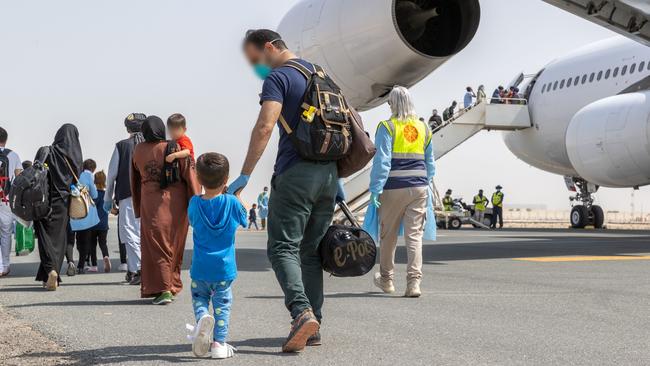 Afghanistan evacuees board a flight to Australia from the Middle East.