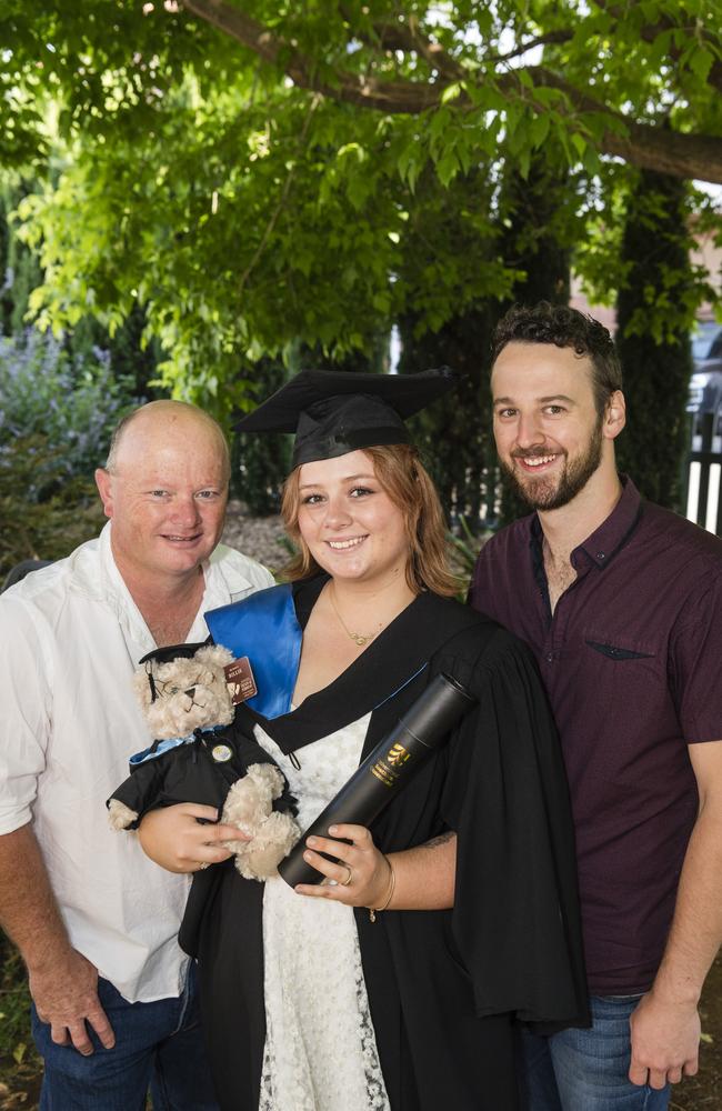 Bachelor of Nursing graduate Courtney Richards with Neale Richards (right) and Ashley Butler at a UniSQ graduation ceremony at Empire Theatres, Tuesday, October 31, 2023. Picture: Kevin Farmer